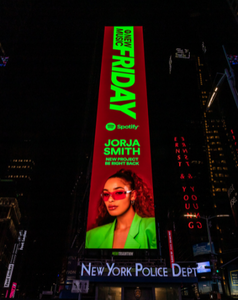 Jorja smith wearing raw burmese curly bundles for her spotify billboard in new york times square